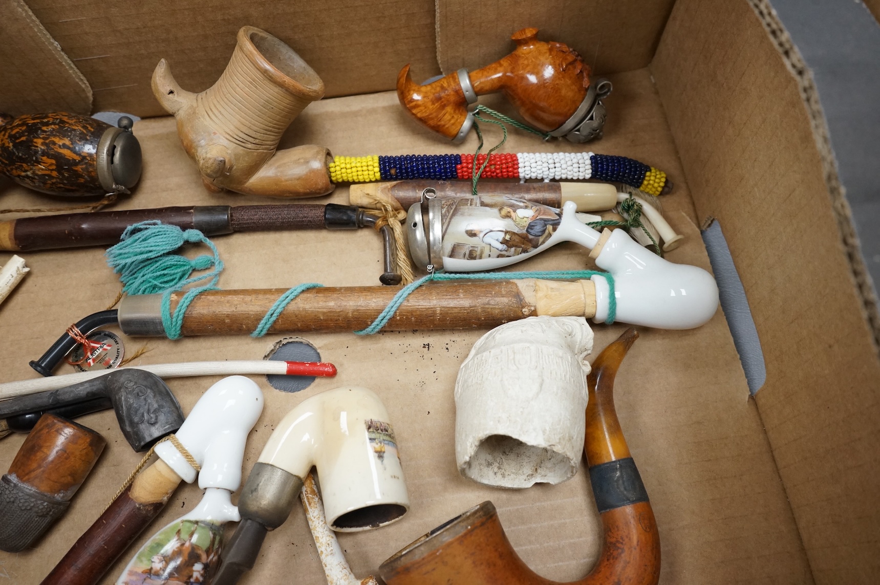 A group of fifteen novelty pipes to include treen, clay and ceramic examples
